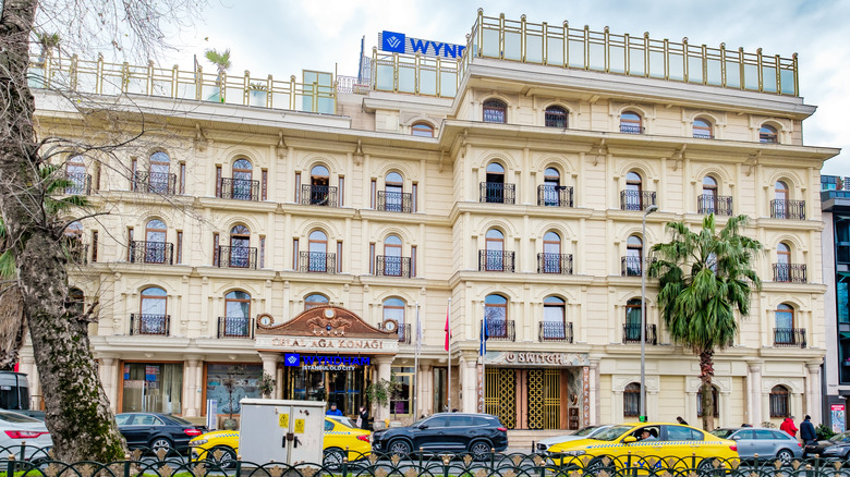 A grand, cream-colored Wyndham hotel with black wrought iron balconies