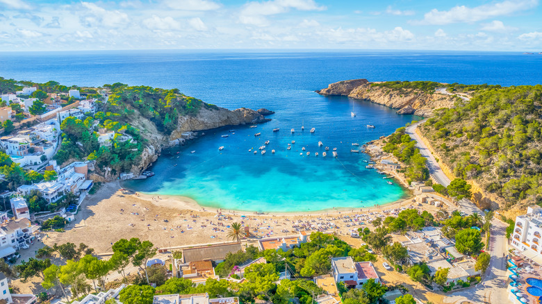 Drone view of Cala Saladeta beach and town on the island of Ibiza in Spain