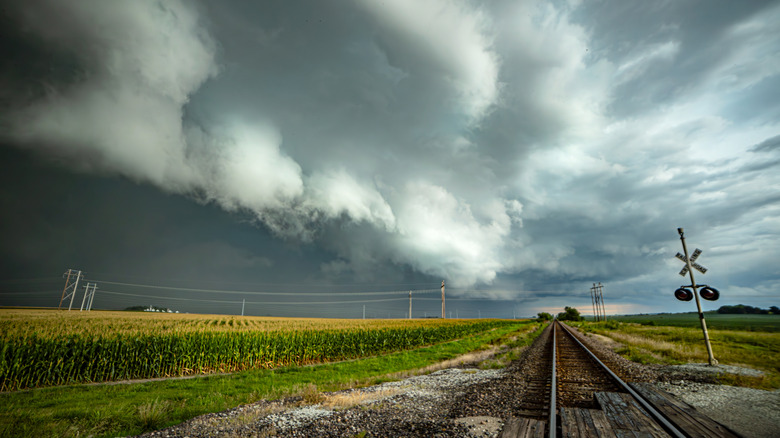 Tornado storm cells form over railroad tracks and a farm in rural Illinois