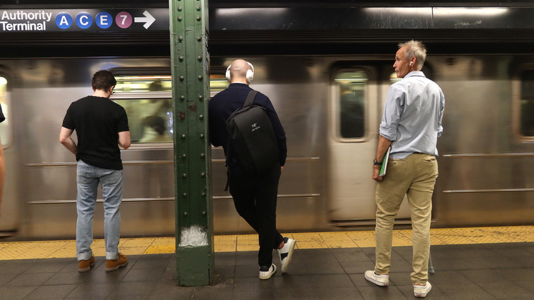 People waiting to board the subway at Times Square Station in New York City