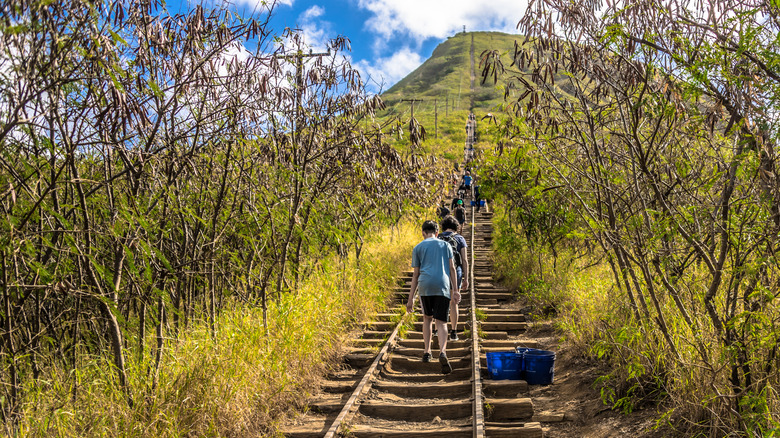 Hikers on the former railroad tracks, now trail, up Koko Crater on Oahu, Hawaii