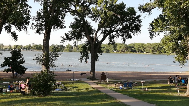 Picnic tables on grassy areas with lake views at Meade State Park, Kansas