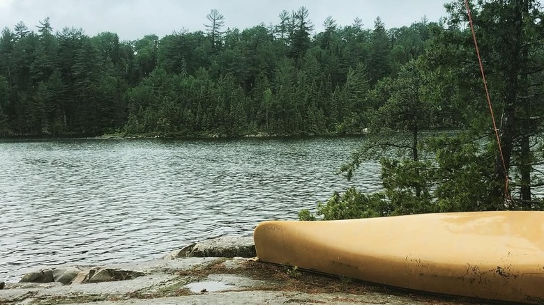 Small boat on the shore of the river on a cloudy day
