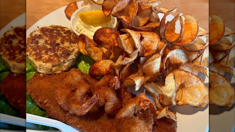 Plate of seafood with homemade chips at Ike's Famous Crab Cakes