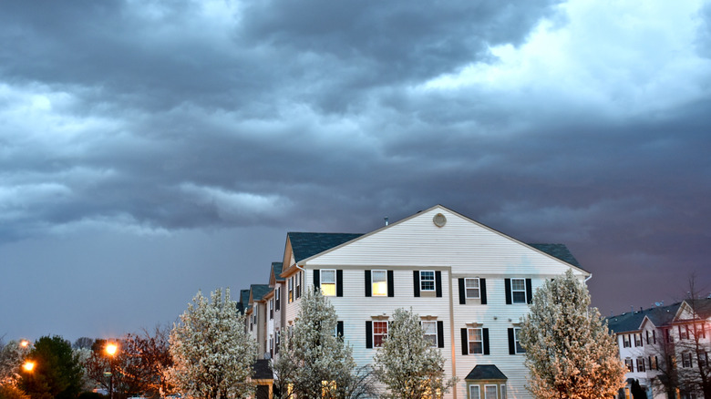 Cloudy night above white homes in town of Odenton, Maryland