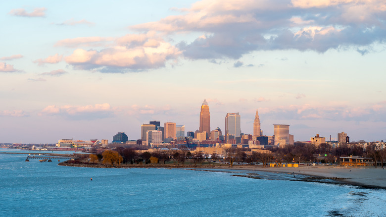 The Cleveland skyline, beach, and Lake Erie's blue water at sunset