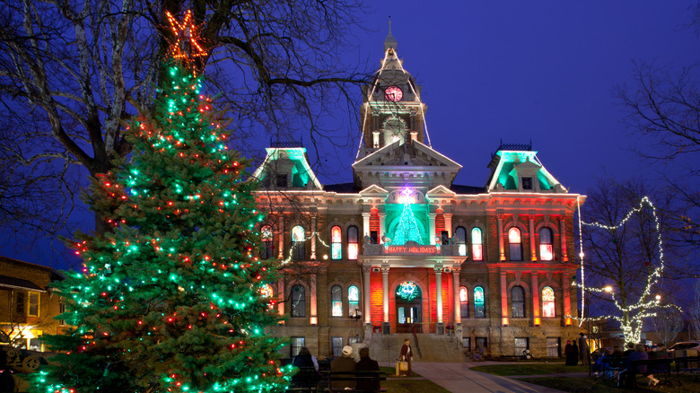 Christmas tree and building decorated with Christmas lights at night in Cambridge, Ohio
