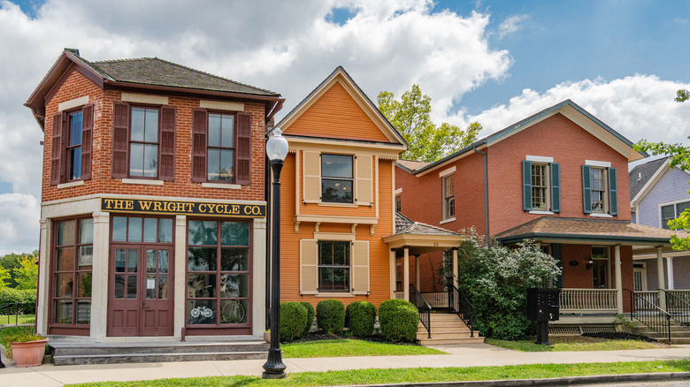 The Wright Cycle Co. next to other historic buildings on a street at the Dayton Aviation Heritage National Historical Park.