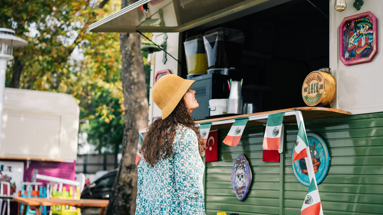 A woman buys from a food truck
