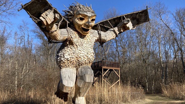 Troll statue in Aullwood Audobon surrounded by bare trees.