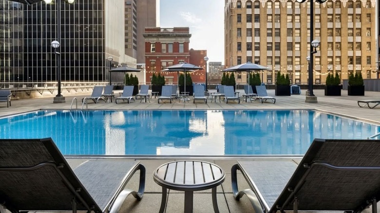 Chairs by a pool overlooking the city