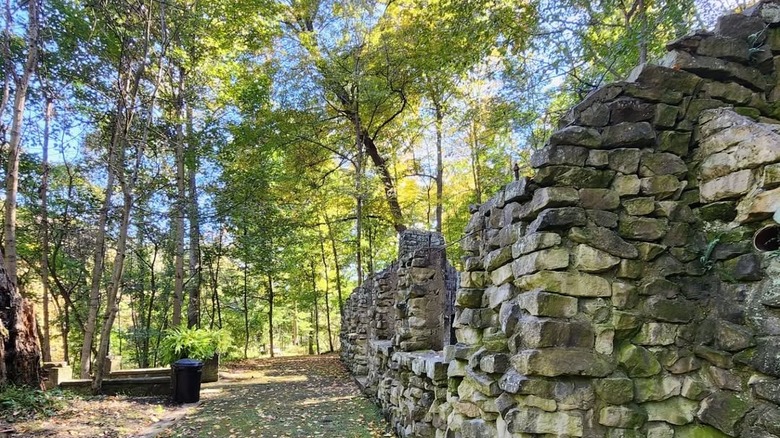 Path through a historic ruin in Beatty Park in Steubenville with trees and blue sky in the background