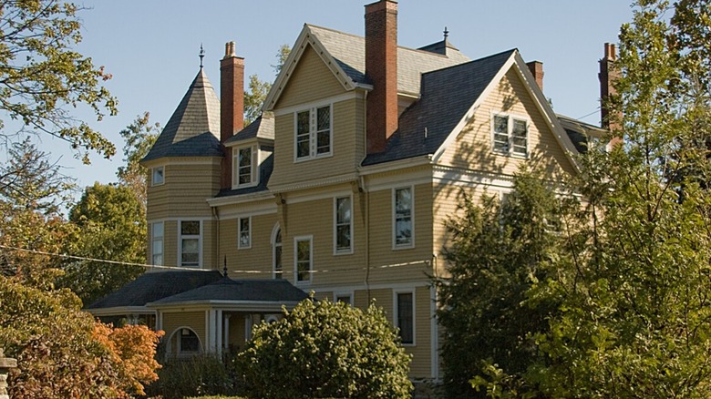 Historical yellow house surrounded by trees in Wyoming, Ohio