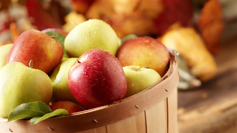 Close up of apples sitting in a basket