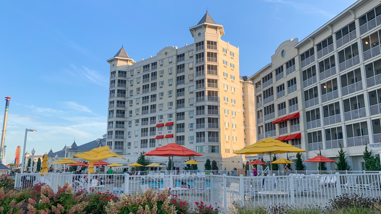 multi-story Hotel Breakers overlooking pool with loungers and colorful umbrellas