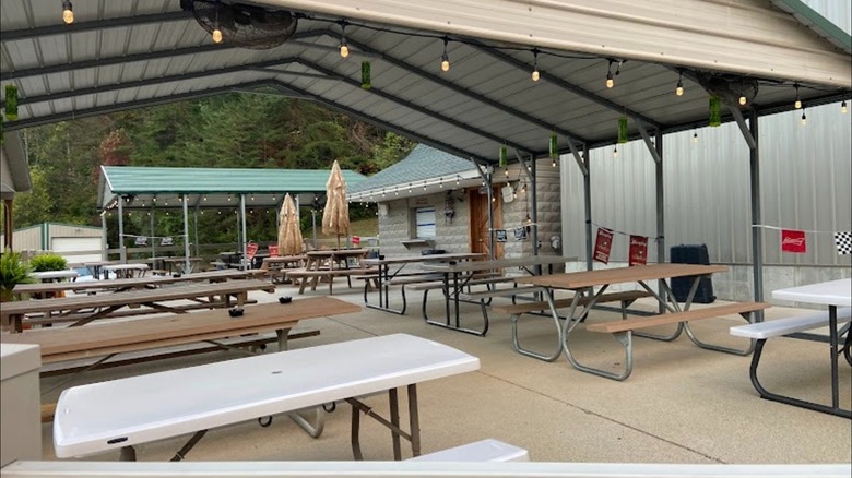 Outdoor seating under a roof at JimBo's Burgers and Beer