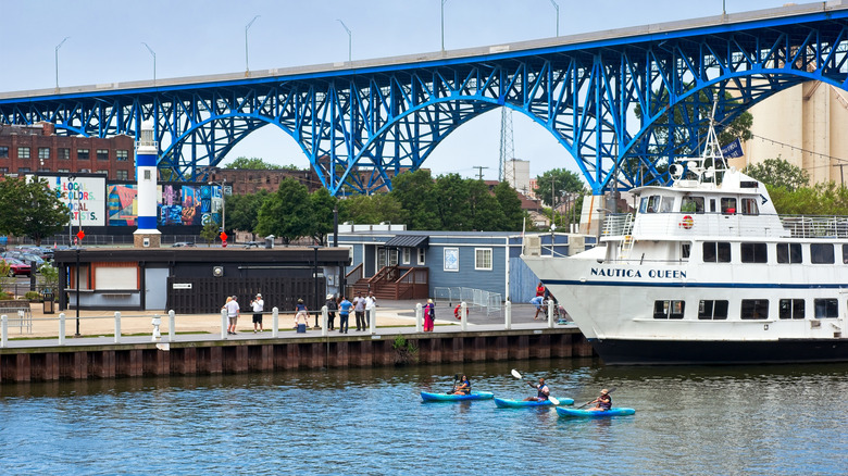Three kayakers on the Cuyahoga River in Cleveland