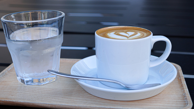 A cup of coffee and glass of water