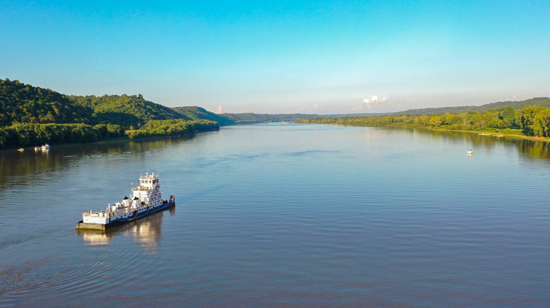 tugboat driving down the Ohio River on a sunny day