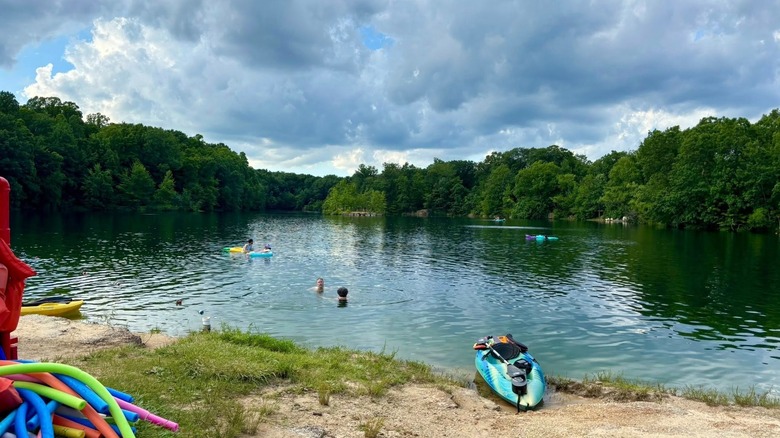 A freshwater lake with a beach and people swimming