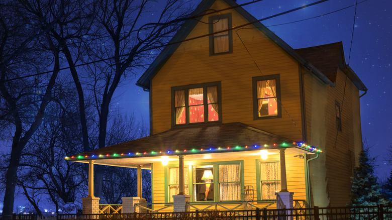 Front view of the house from the film "A Christmas Story" at night with lights on in and around the house.