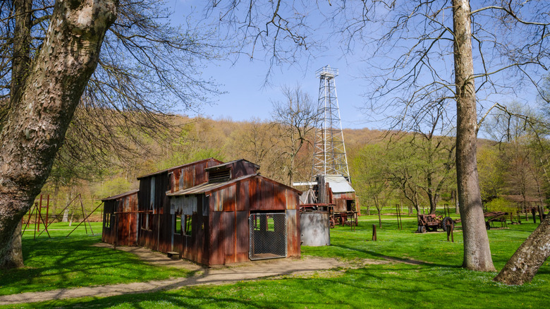 Grassy park with trees and remnants of an oil drill site