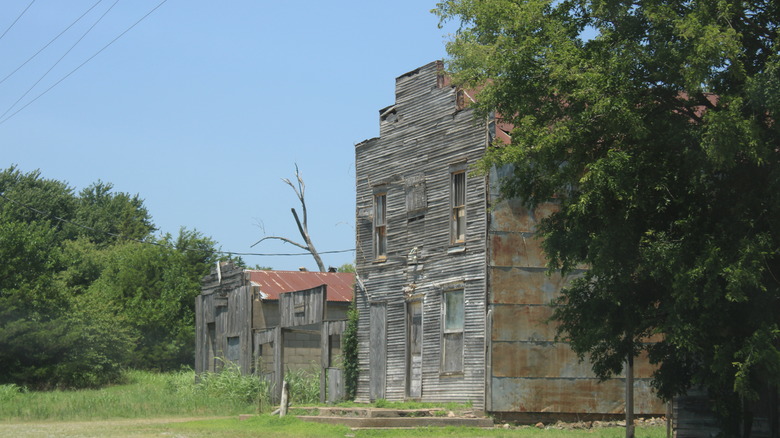 Old, stained wood buildings in Ingalls, Oklahoma