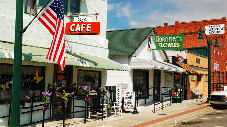 The front of a local cafe and stores in Claremore's Lilac District downtown on a sunny day.