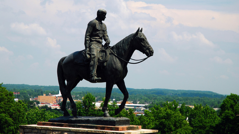 A statue of Will Rogers, sitting on a horse outside the Will Rogers Memorial Museum.