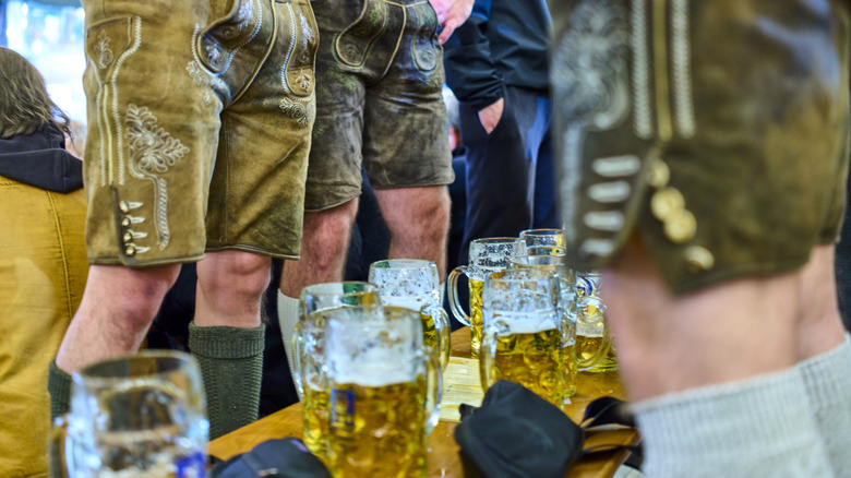 People at the Augustiner standing on the benches while the tables remain clear