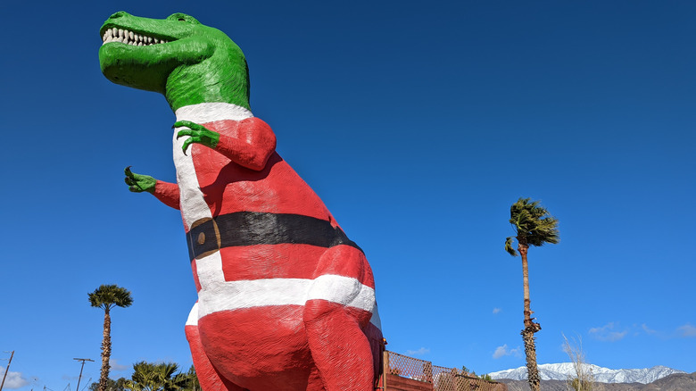 A T-Rex statue in a Santa Claus Suit at Cabazon Dinosaurs in California