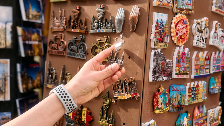 A tourist holding a magnet