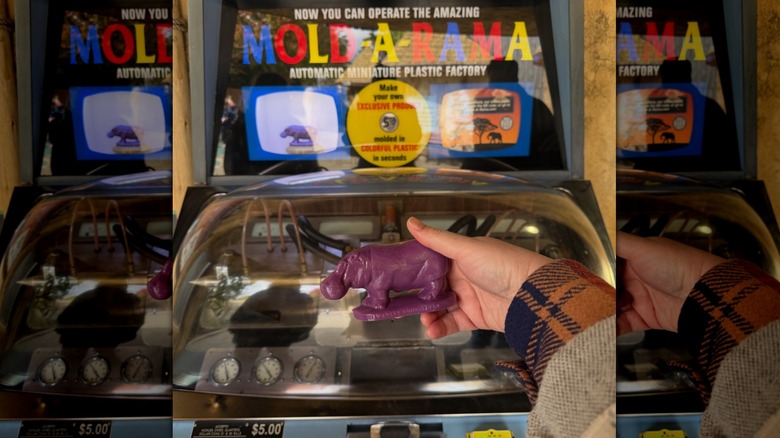A hand holding a Mold-A-Rama figure.