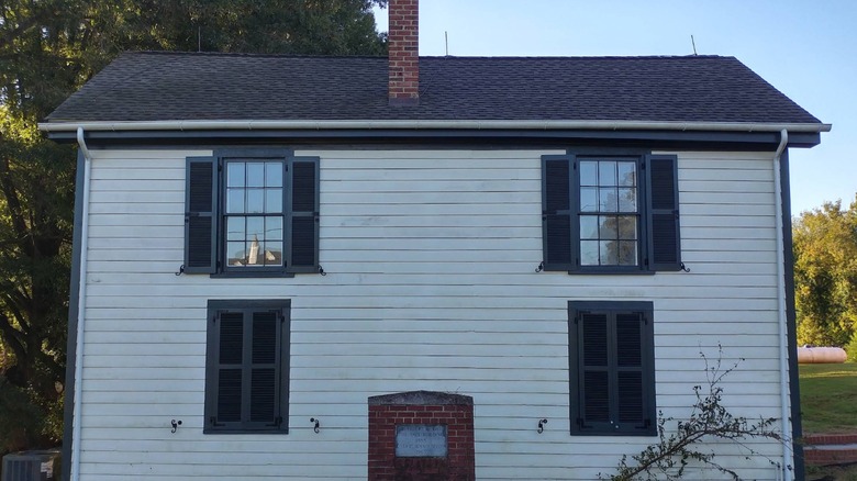 Abandoned white house with blue roof at Saint Paul's College