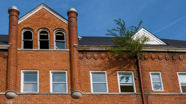 Virginia Intermont College red brick building boarded and broken windows against blue sky