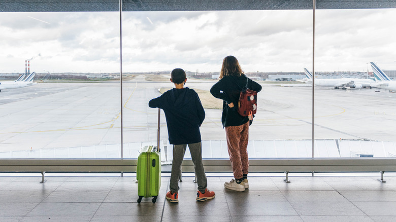 Children waiting for a flight in an airport terminal