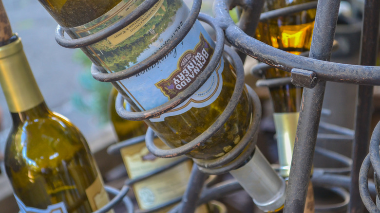 Bottles of Bernardo Winery wines rest in metal holders