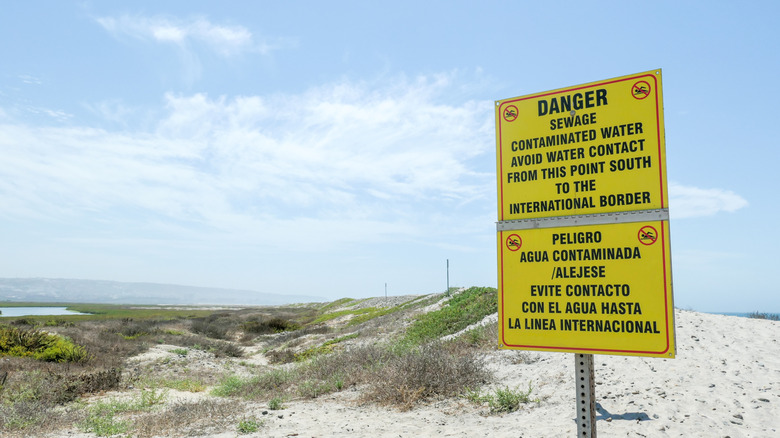 A warning sign of contaminated water at a beach near the Tijuana River in San Diego, California