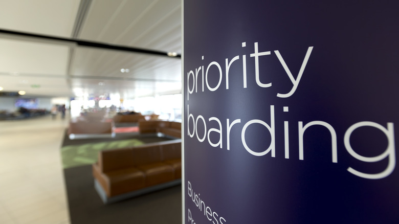 A "priority boarding" sign in a mostly vacant airport terminal