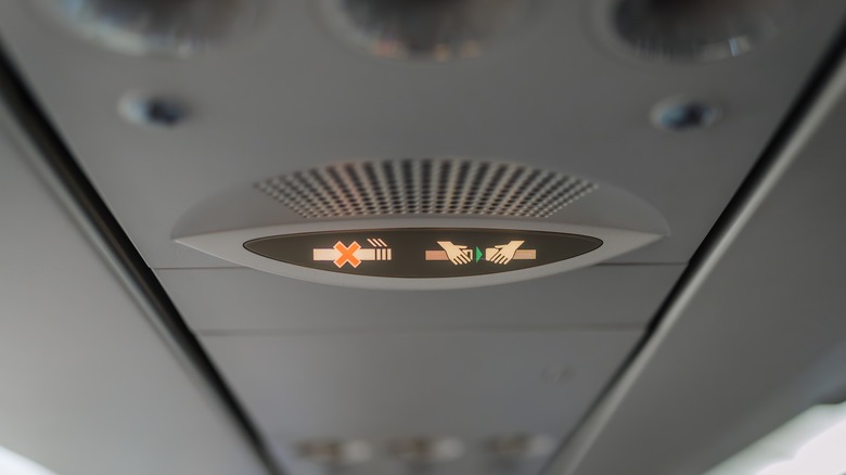 Seatbelts fastened light on a plane