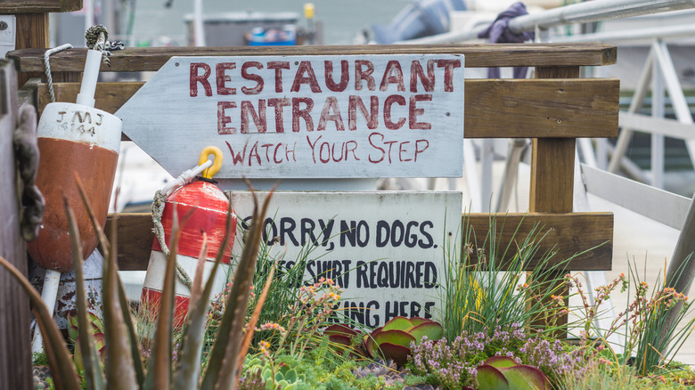 Restaurant signage on a dock in Gloucester, Massachusetts.