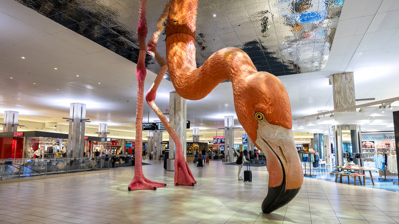 A giant flamingo sculpture stands in the middle of Tampa International Airport