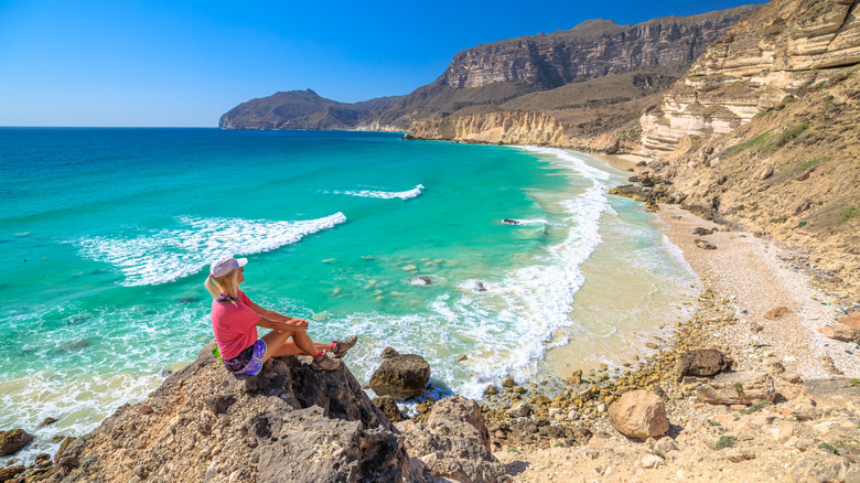 Woman on a beach near Salalah, Oman.