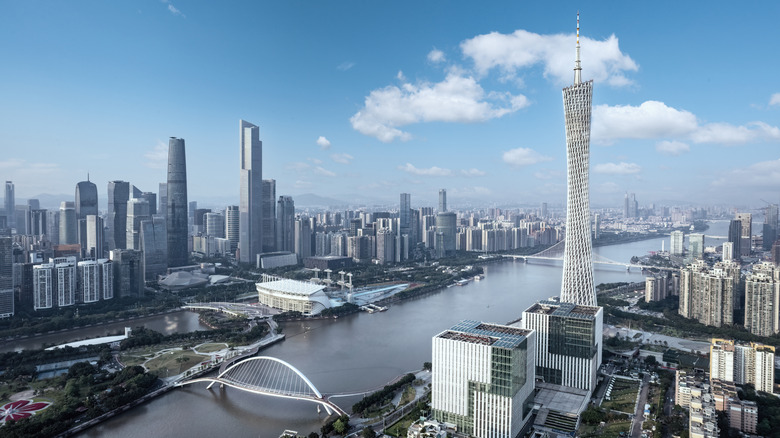 City skyline separated by a river, with two bridges connecting both shores.
