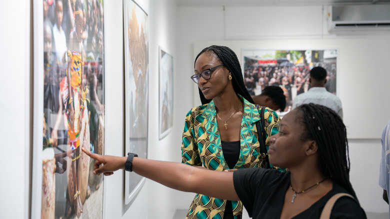 Visitors look at a photo in a gallery in Accra, Ghana