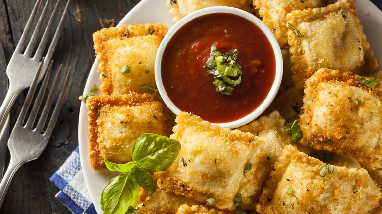 Fried ravioli and marinara sauce on a plate