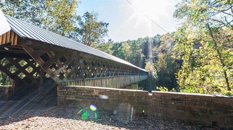 Historic wooden covered bridge surrounded by trees