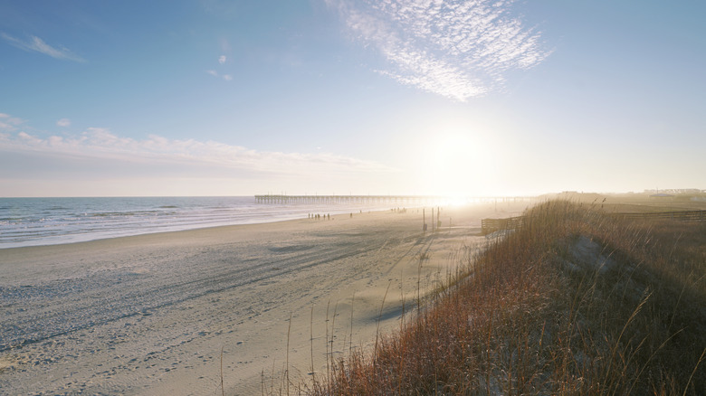 A long sandy shore next to the ocean in Sunset Beach, North Carolina
