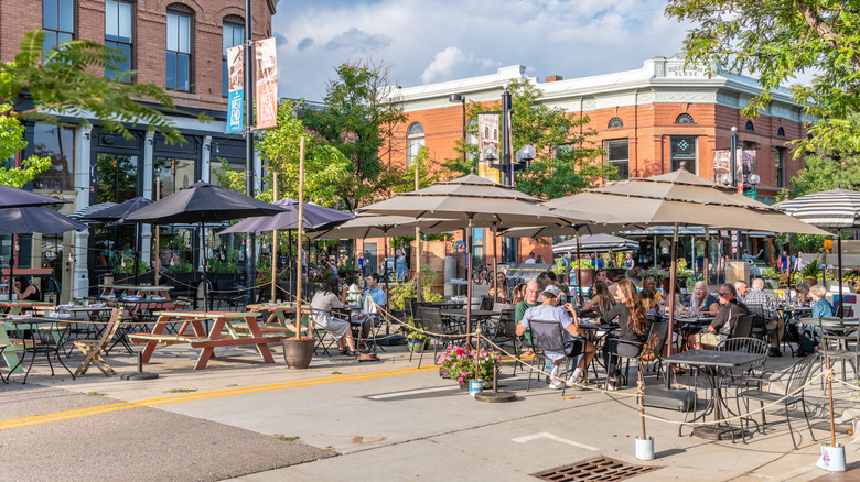 street shot of Boulder's Pearl Street Mall and people dining on the street