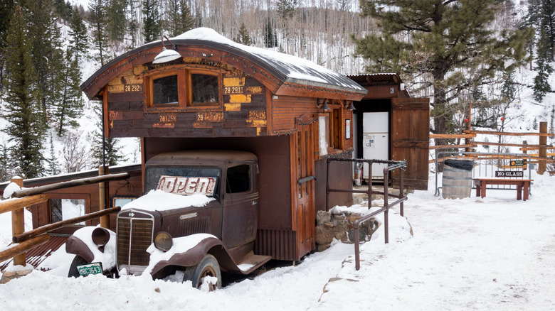 Old truck camping accommodation in Strawberry Park Hot Springs in winter